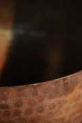 A brass singing bowl without traditional coating, leaving the metal piece with naked surface, natural burn marks and unique reddish due to burning reaction.